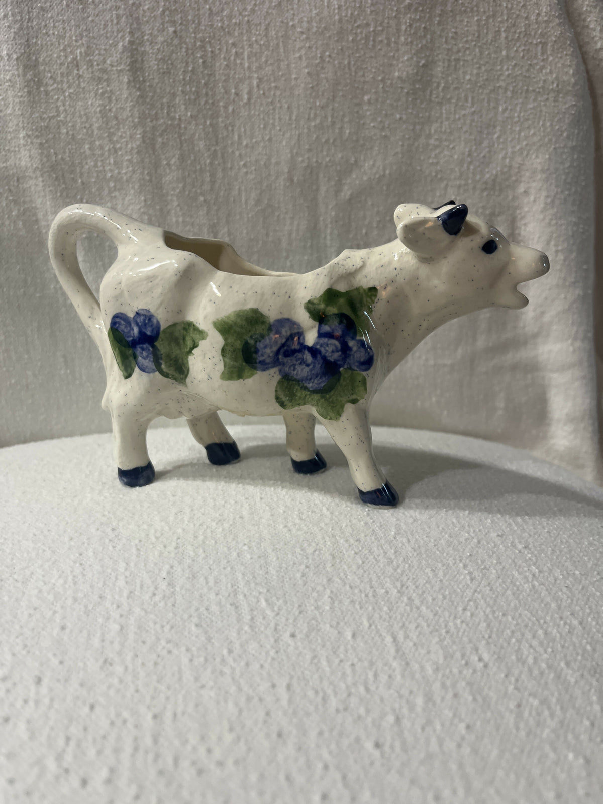 Ceramic cow creamer with blueberry fruit